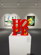 Robert Indiana HOPE Red Yellow sculpture displayed in contemporary gallery

